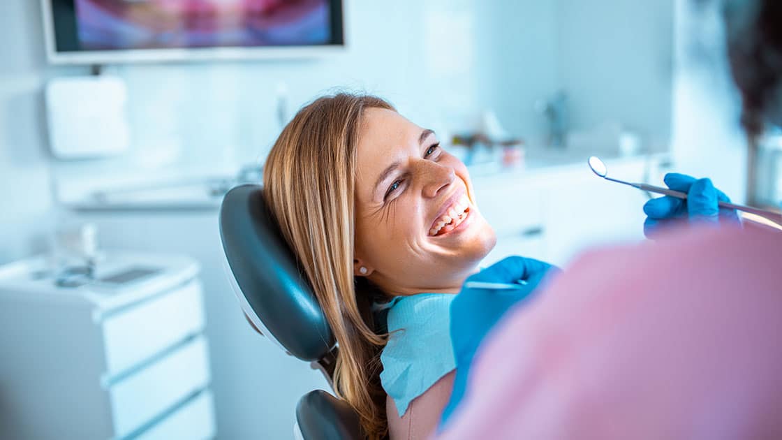 Smiling Woman in Dental Chair